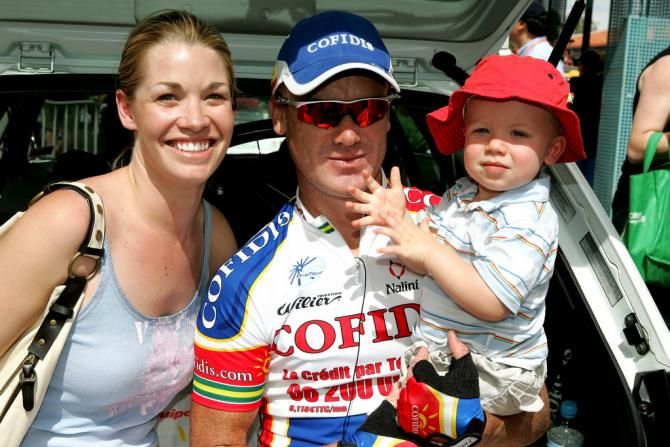 Stuart O'Grady with his wife and child before a stage
