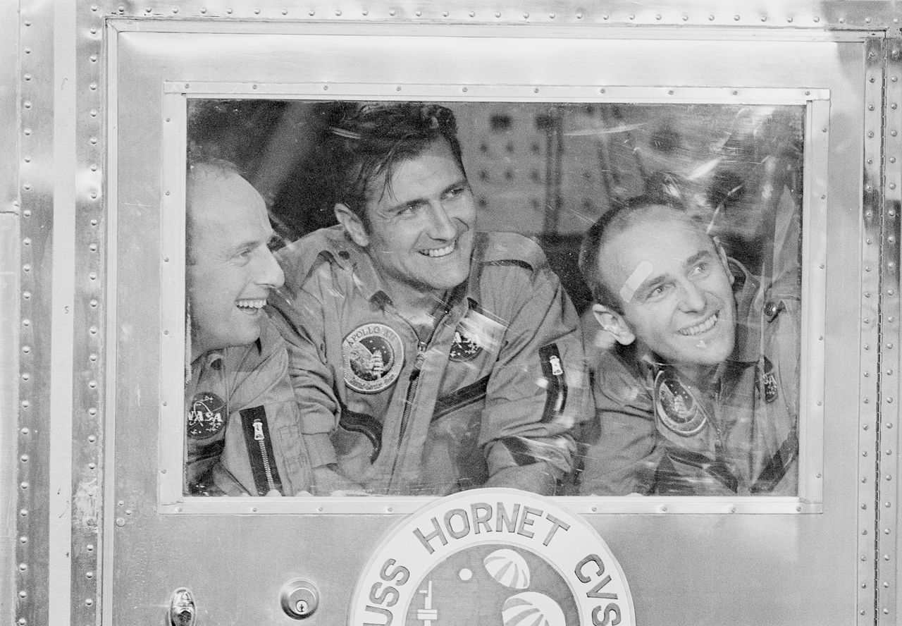 NASA's Apollo 12 astronauts Charles Pete Conrad (left), Richard Gordon (center) and Alan Bean smile in an isolation room after returning from the moon on Nov. 24, 1969.