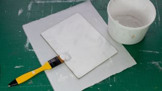 Stick the canvas to your board using primer