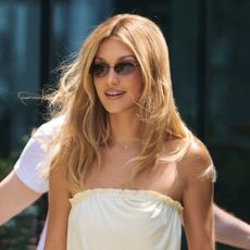 Bella Hadid wearing a butter yellow strapless dress and yellow slingback heels 