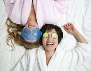 Women in bathrobes wearing eye masks