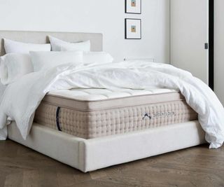 DreamCloud Luxury Hybrid Mattress on a bed against a white wall.