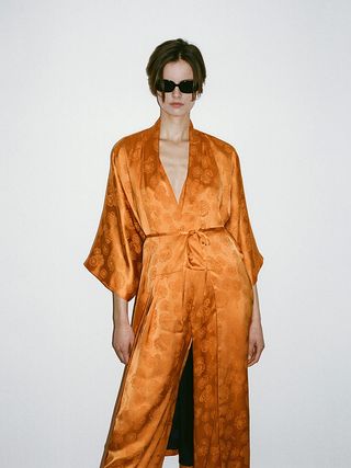 Model wears orange silk kimono from Francon Editions The Lake House collection