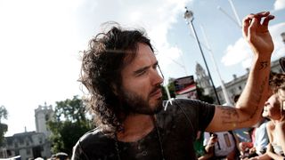 Comedian Russell Brand arrives for a protest against austerity