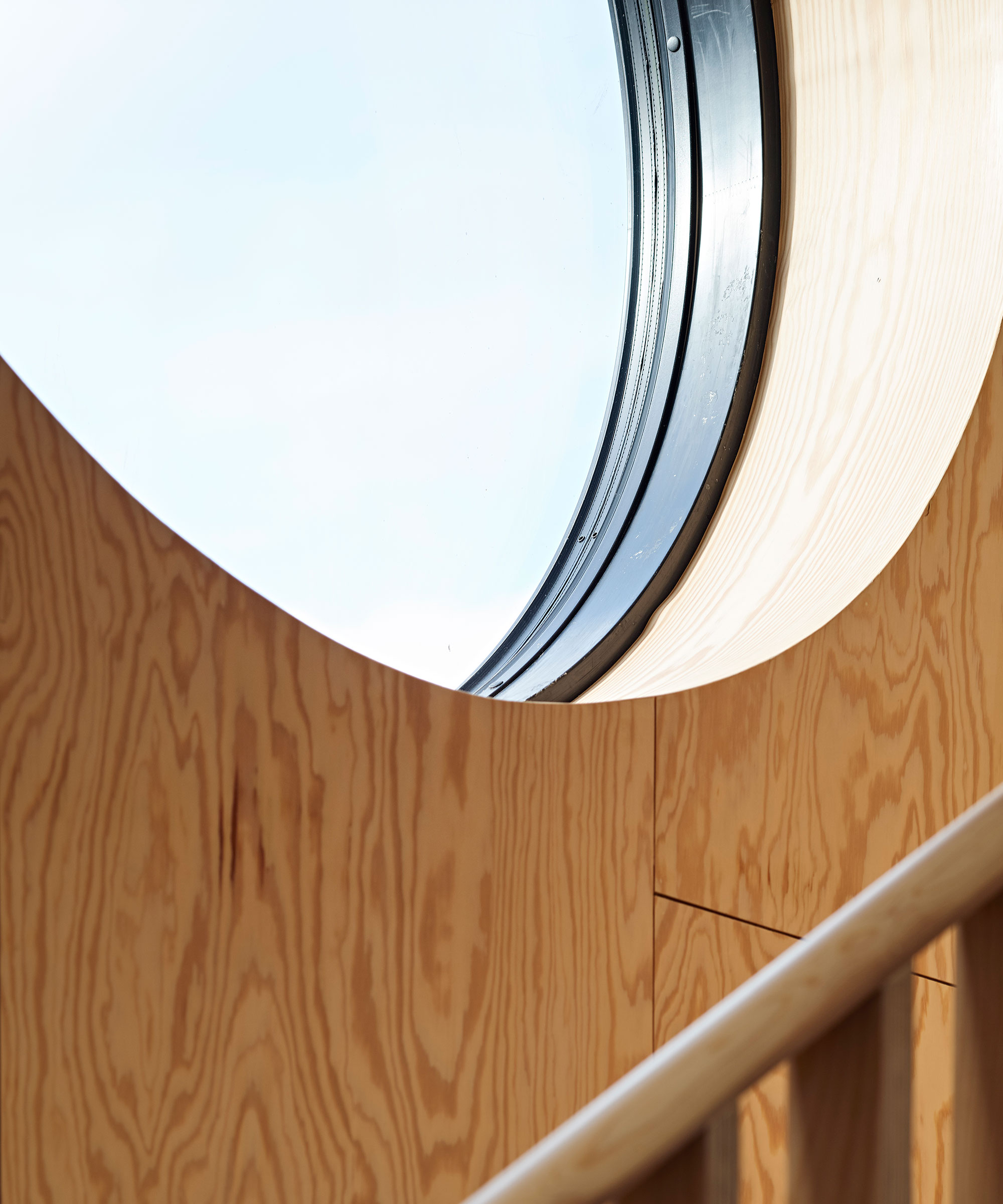 circular staircase in wooden clad wall on staircase
