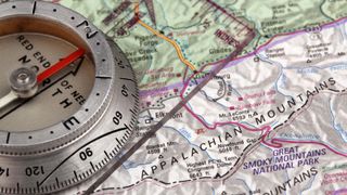 A navigational compass on a map of the Appalachian mountains