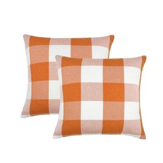 A set of two orange and white plaid pillows