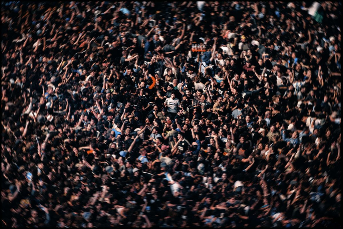 Oasis fan in muddle of crowd.