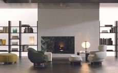 Milan Design Week Minotti 2 accent chairs, green and white in large living room with bookshelves