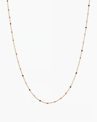 A gold chain necklace with colorful beads