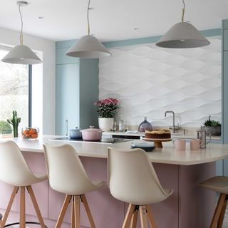 pink and blue kitchen with white bar stools