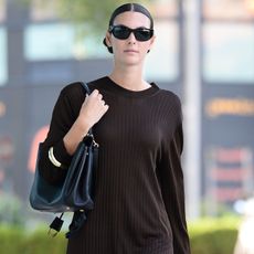 Vittoria Ceretti wears a brown sweater dress in Milan