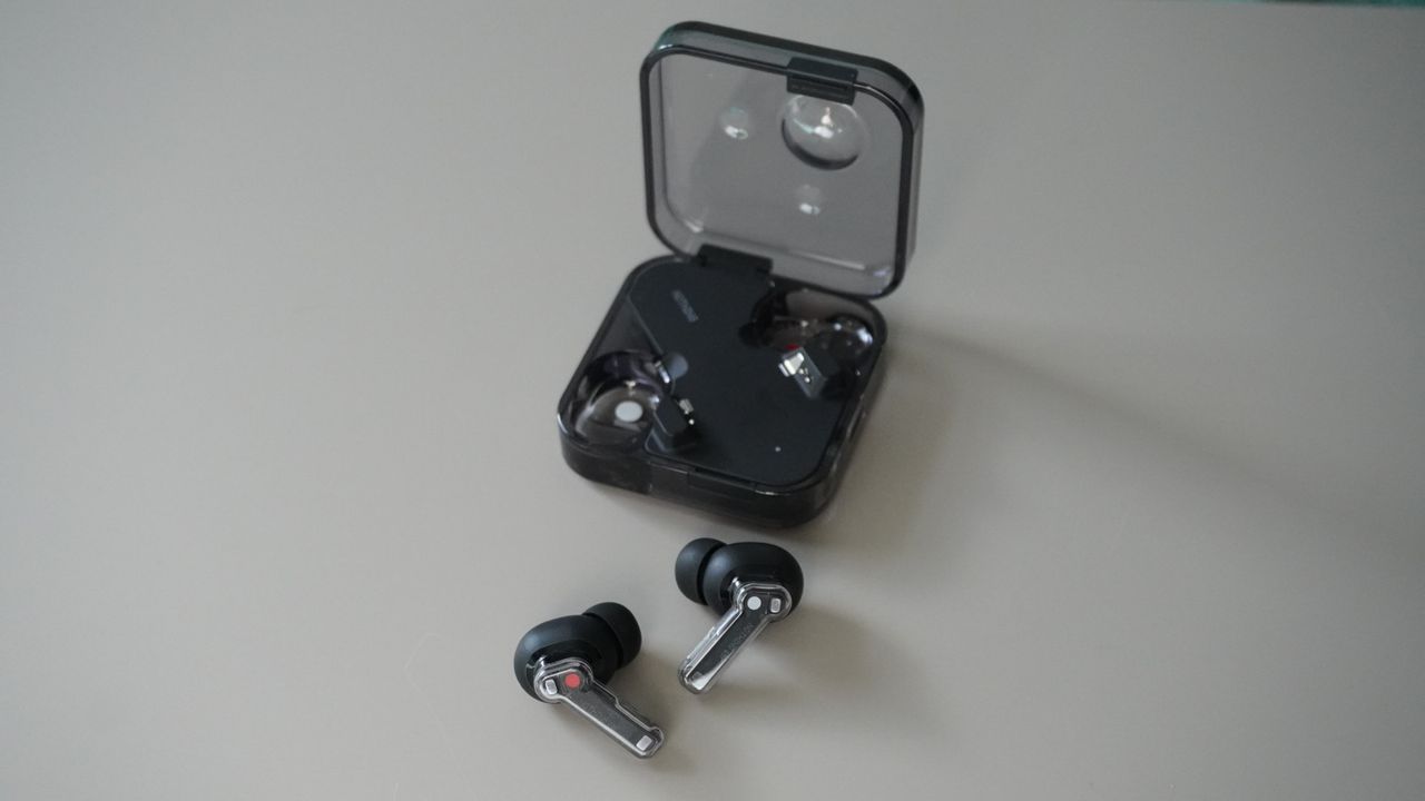 The Nothing Ear wireless earbuds in black on a grey background