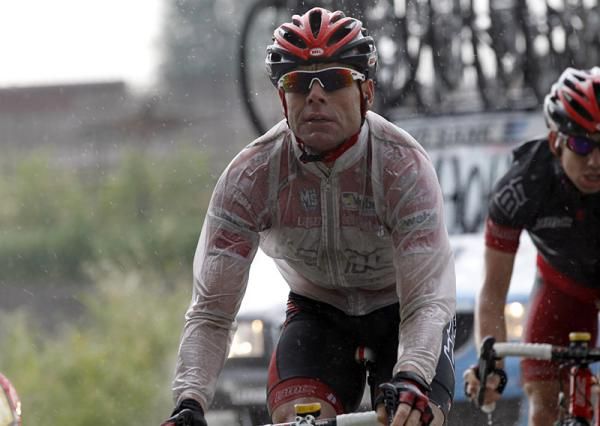 Cadel Evans (BMC Racing), wearing the red jersey for leading the points classification, endures a rainy stage nine.