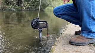 Joby SeaPal waterproof case being pulled out of a river
