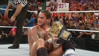 CM Punk holding the WWE Championship at Money in the Bank 2011