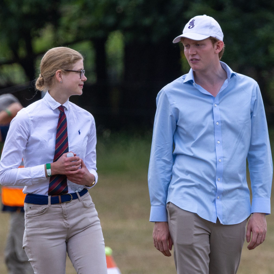 Lady Louise Windsor standing next to Felix da Silva-Clamp in a field