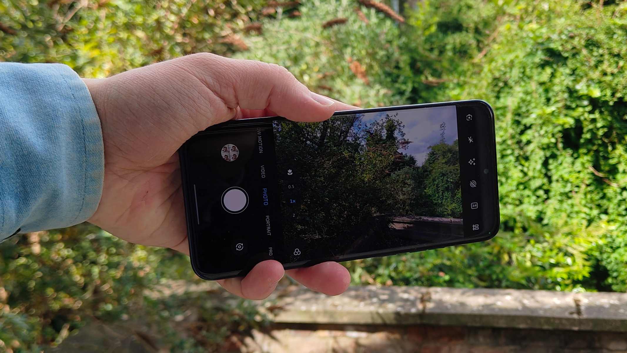 The Motorola Edge 70 Fusion's camera viewfinder, pointed at bushes.
