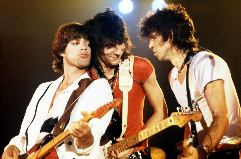 Photo of ROLLING STONES and Mick JAGGER and Ron WOOD and Keith RICHARDS; L-R Mick Jagger, Ron Wood and Keith Richards performing on stage at the Oshawa Civic Auditorium, playing a benefit concert 