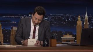 Jimmy Fallon writing out a Thank You note on The Tonight Show