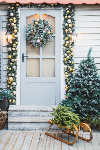 front door with foliage and bauble garland