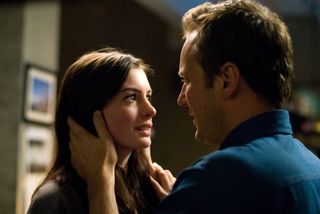 patrick wilson touches anne hathaway's face in a still from passengers