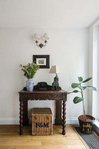 hallway with antique sidetable and flowers