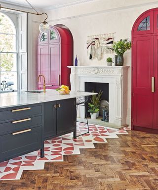 Colorful kitchen with pink cabinets, parquet floor and pink tiles