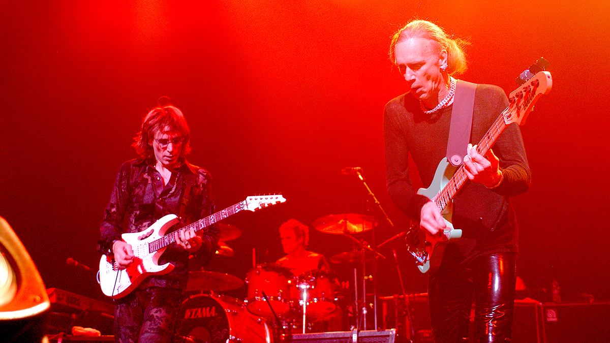 Steve Vai and Billy Sheehan, Chicago, Illinois, October 24, 2003. Behind them is drummer Jeremy Colson