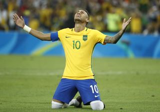 Neymar sinks to his knees after scoring the winning penalty for Brazil in the 2016 Olympic final against Germany in Rio.