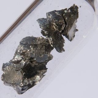 A 1.5-gram piece of ultrapure praseodymium in a vial of argon, about 0.5 by 1 cm.