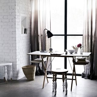home office room with white wall and wooden table with stool