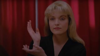 Sheryl Lee as Laura Palmer with her hands up in the Black Lodge on Twin Peaks