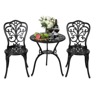 A Hopwood Round 2 - Person Outdoor Dining Set laid with flowers and wine, against a white background