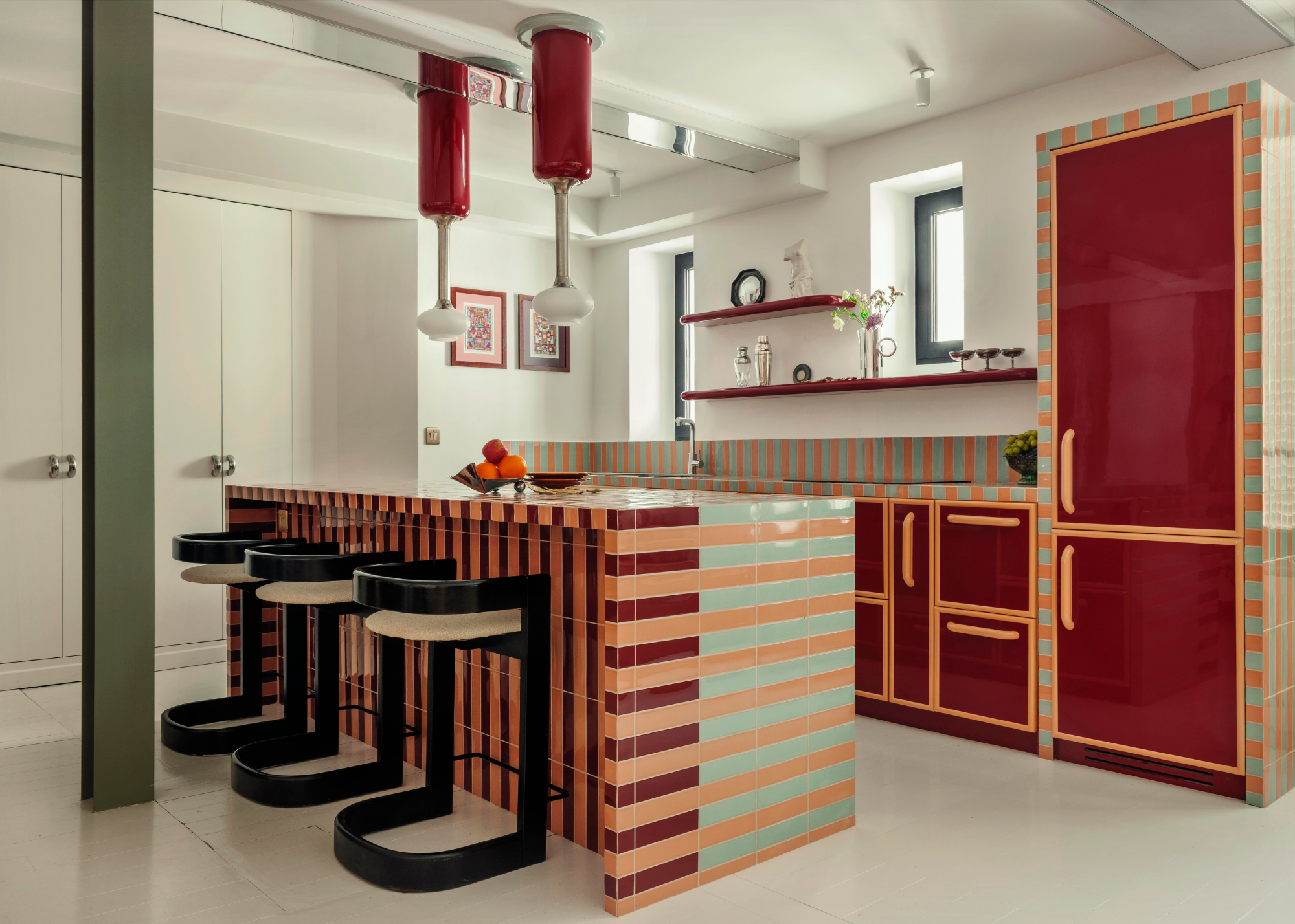 a cool modern kitchen with striped tile kitchen island and glossy red cabinets