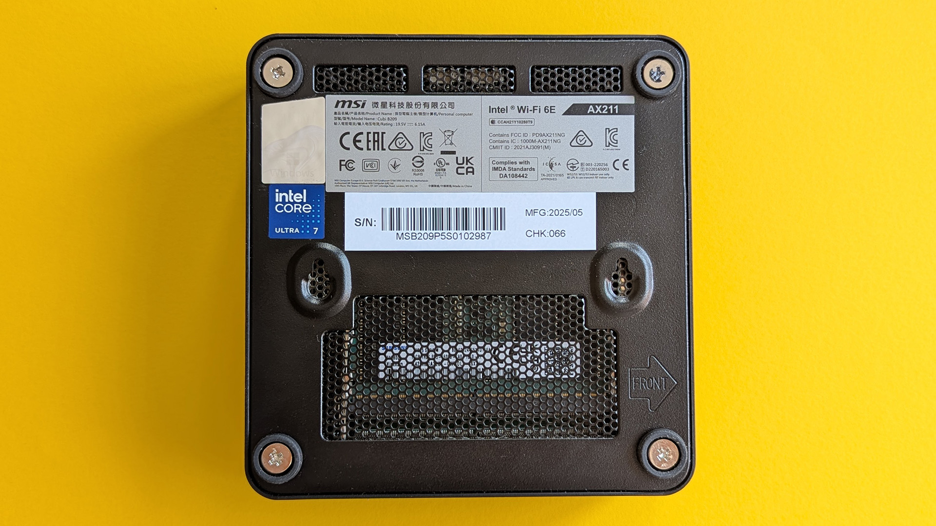 MSI Cubi NUC A1 1UMG mini PC underside showing screw mounts and Intel Core Ultra logo