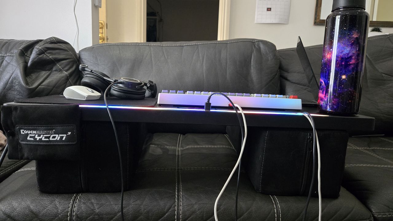 Couchmaster Cycon3 set-up on a sofa with a keyboard and mouse.