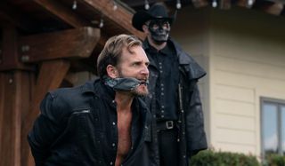 Josh Lucas gagged and tied by a purger in The Forever Purge.