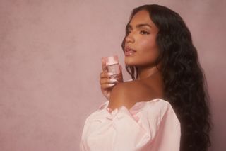 Content creator Monet McMichael poses with Snif's Rose Era Eau de Parfum wearing a powder pink dress