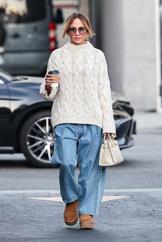 Jennifer Lopez grabbing coffee and pastries in a cable knit sweater, UGGs, and a Birkin 25.