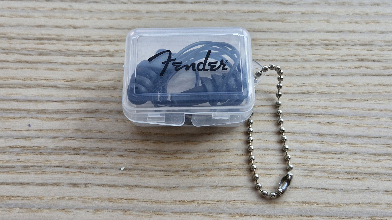 Fender Musician earplugs in their case on a wooden surface
