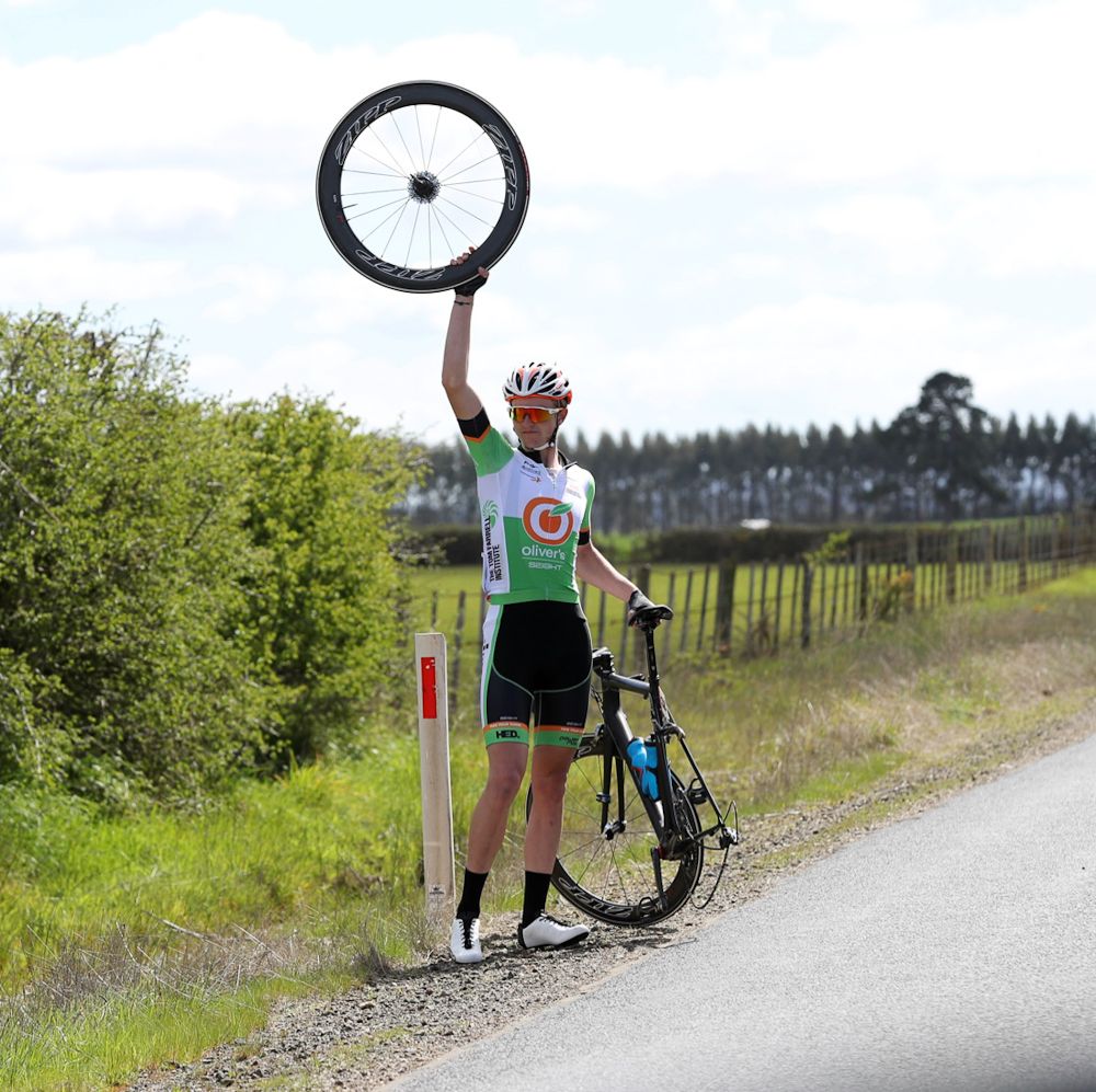 An Oliver's Racing Team rider calls for assistance after having a mechanical.