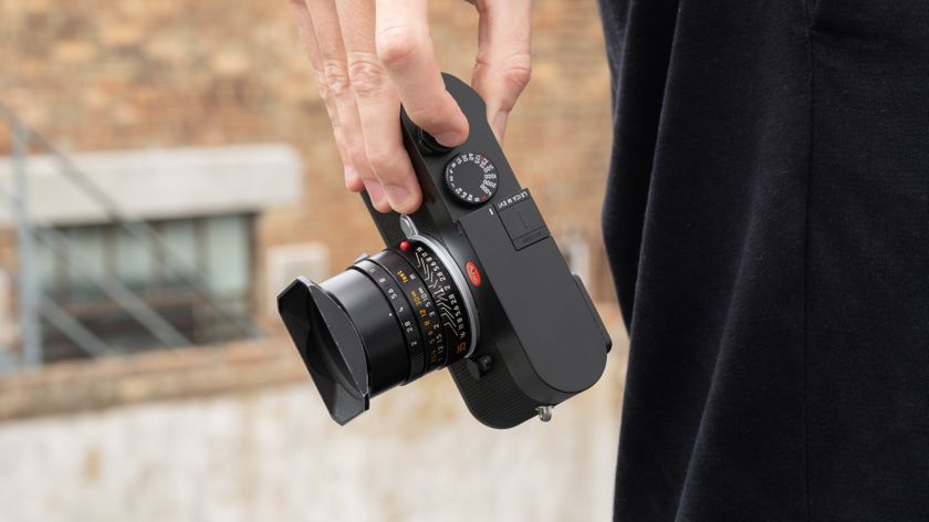 Leica M EV1 digital camera with lens attached, held in a person&#039;s hand