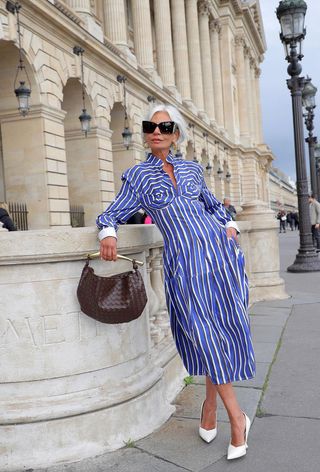 a photo of a shirtdress outfit with a blue stripe dress with white wedges and brown Sardine bag