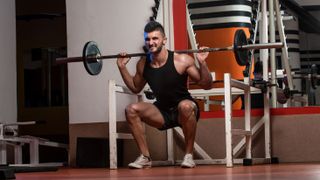 Man performing a barbell squat