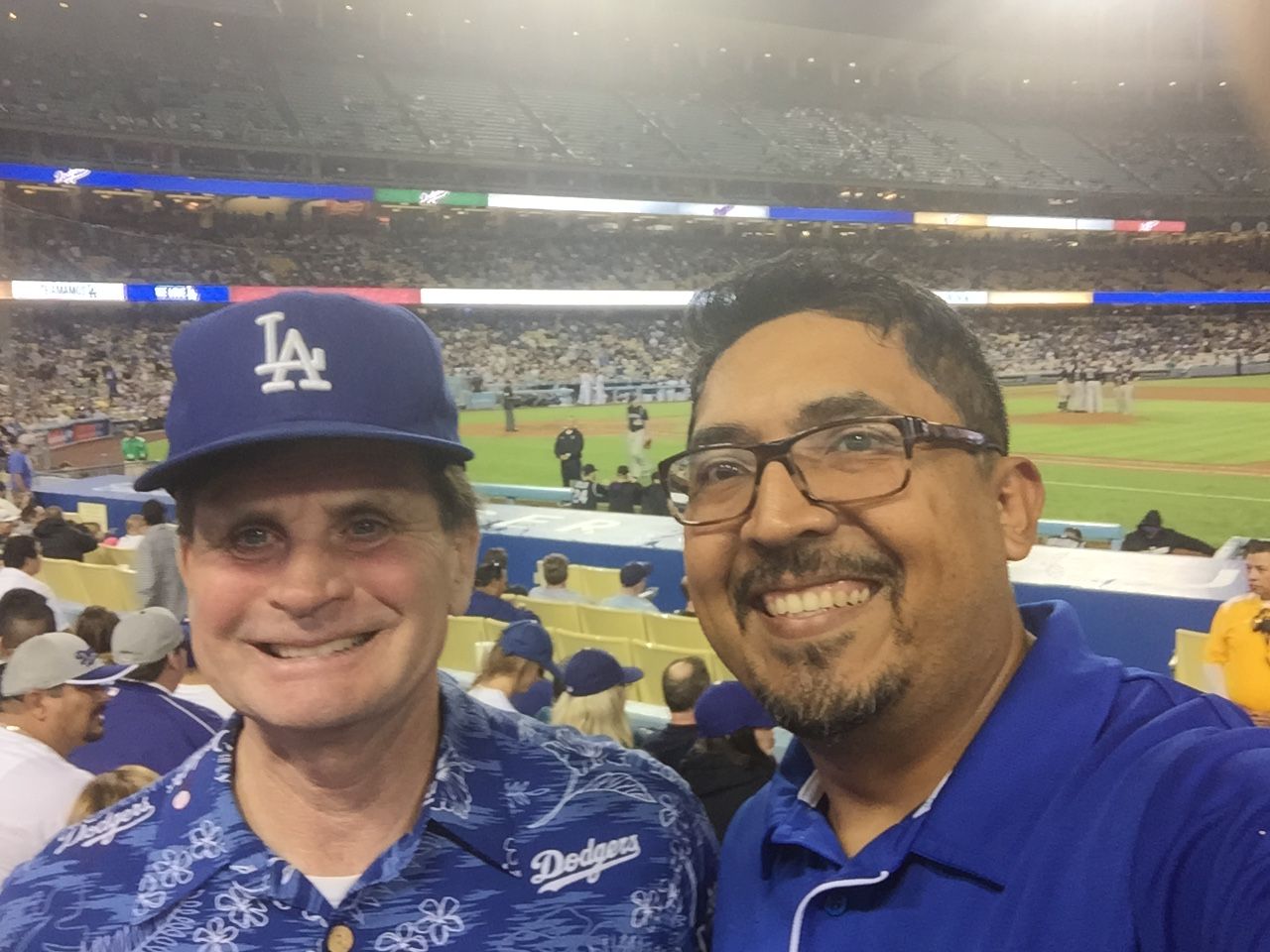 Two men taking a selfie at a Dodgers game