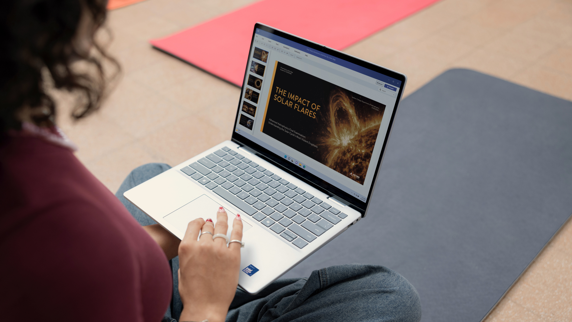 Dell XPS 13 laptop showing someone working on a presentation in Windows 11, with their hand on the trackpad