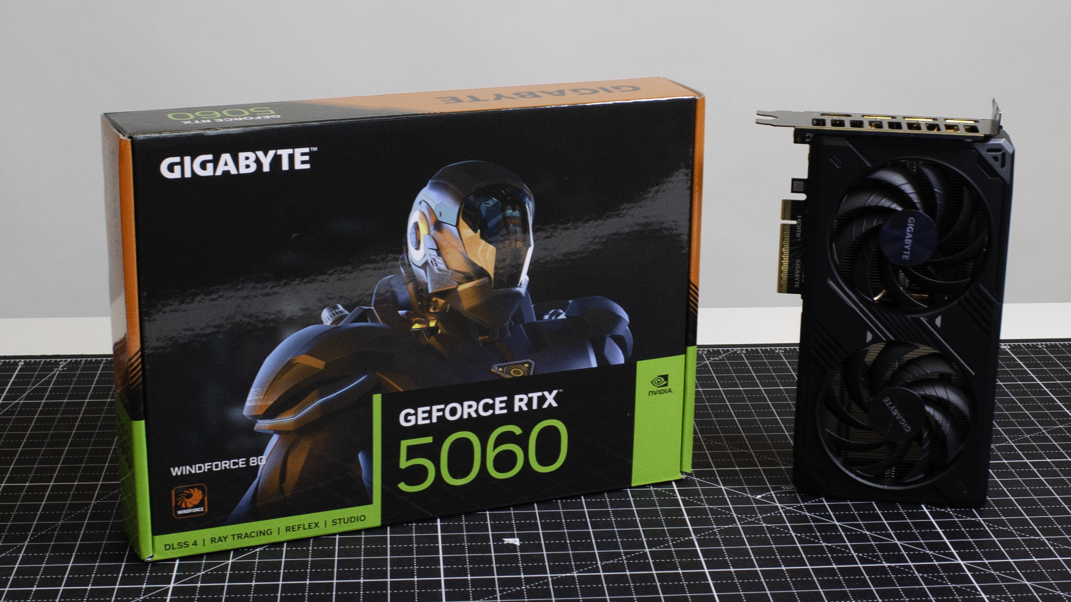 An RTX 5060 on a desk with its retail packaging