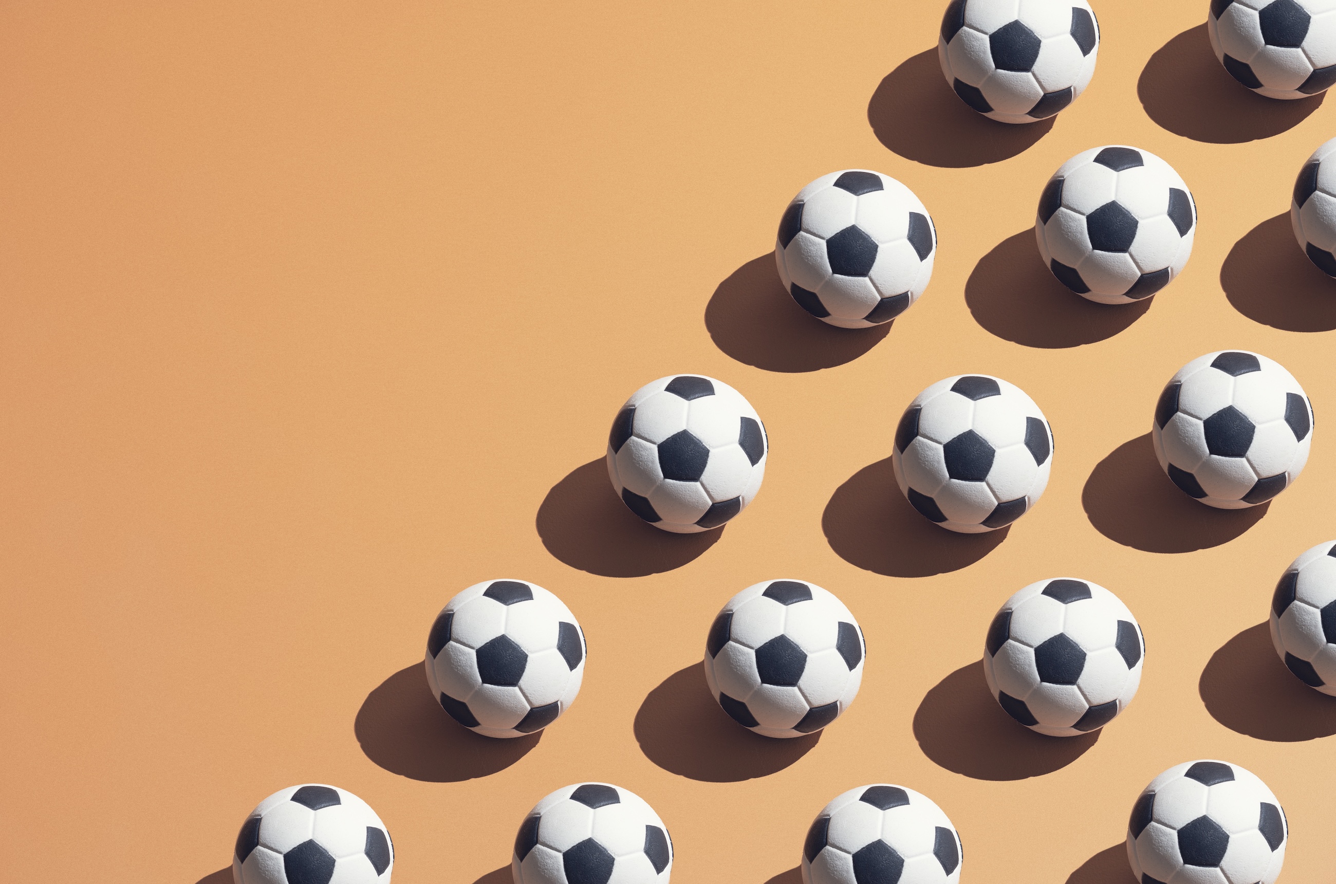 footballs on an orange background
