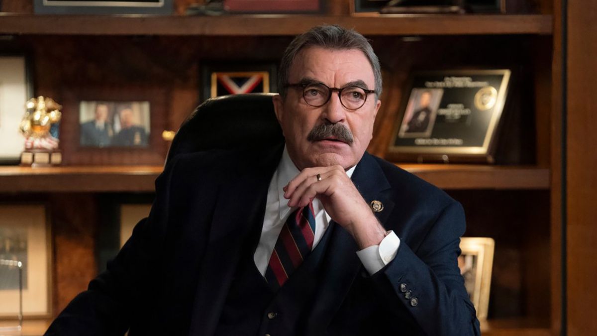 Tom Selleck as Frank Reagan sitting at desk looking serious.